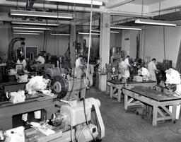 Students at worktables in an electronics workshop, ca. 1962
