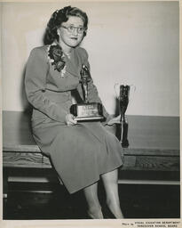 Beauty Culture student Melita Lasko with trophies, ca. 1951
