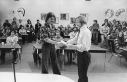 Instructor shaking hand with a student