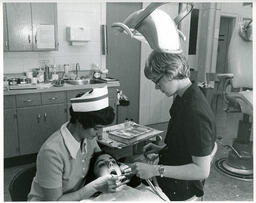 Dental student works on patient