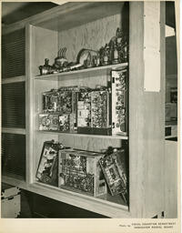 Shelf full of electronics, ca. 1957