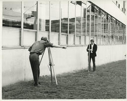 Two students surveying, ca. 1972