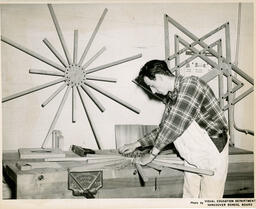 Student works on starburst wood project, ca. 1951