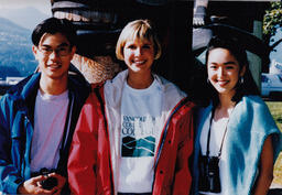 3 students in front of totem pole