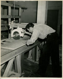 Student working with a circular saw, ca. 1949