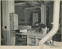 Student building wooden kitchen counter, ca. 1957