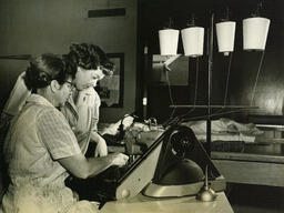 Two students at sewing machine
