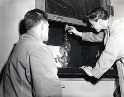 Students doing an experiement at a windowsill, ca. 1962