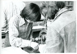 Students work on a piece of equipment