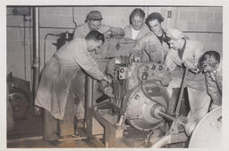 Diesel students and instructor around a large engine