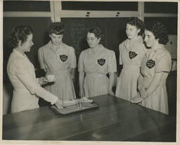 Nursing students learning how to serve on a tray