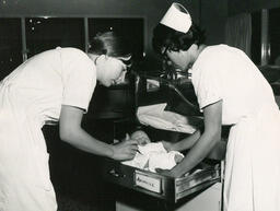 Nursing students with baby, ca. 1972