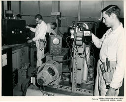 Students working on electronic machines