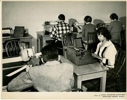 Five students typing in a classroom, ca. 1960