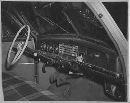 Car dashboard and steering wheel, ca. 1950