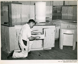 Student working on a kitchen drawer, ca. 1950