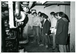 Group of students look at a machine