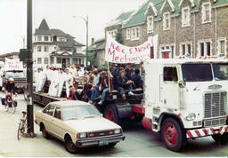Diesel students site on a flatbed truck during the "Last Great Trek" ca. 1982