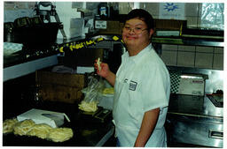 Student packaging pasta in a kitchen