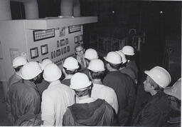 Students in hardhats on a tour of industrial building