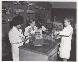 Students using beakers in biology class, ca. 1969