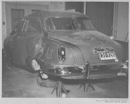 Car with dented side in body shop, ca. 1951