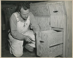 Carpentry working on wooden drawer, ca. 1950
