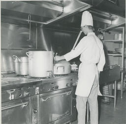 Chef stirs food in pot