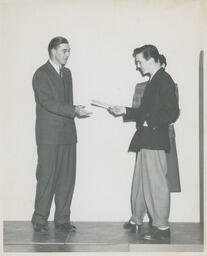 Beauty Culture student receives diploma, ca. 1950