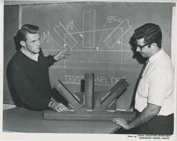 Students at a chalkboard showing structural steel diagrams, ca. 1968