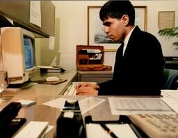 Student typing at computer