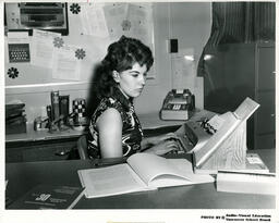 Person types from notes on a stand, ca. 1972