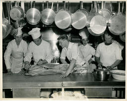 Instructor cutting open a pig
