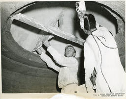 Two plastering students working on a ceiling circle, ca. 1955