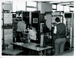 Students working on large electronic machines