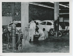 Collision students work on Volkswagen Beetle