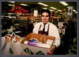 Student holds box of groceries