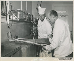 Student learning how to saw pork, ca. 1959