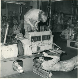 Diesel students working on machine