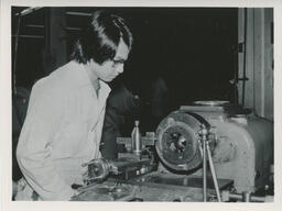 Student looking at a machine