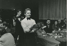 Two servers serve food