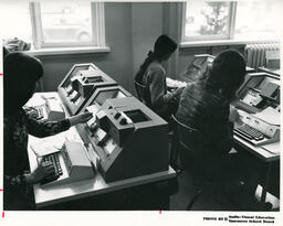 Students with typing machines in a classroom, ca. 1972