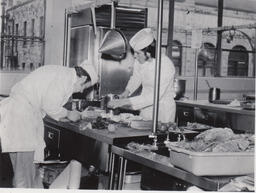 Culinary students chopping vegetables in kitchen