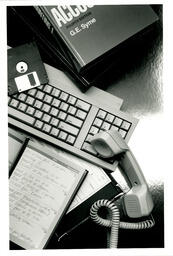 Keyboard, phone, floppy disk, book montage
