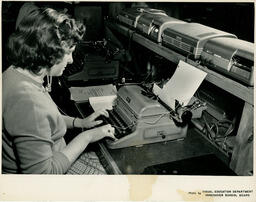 Student working on a typewriter, ca. 1957