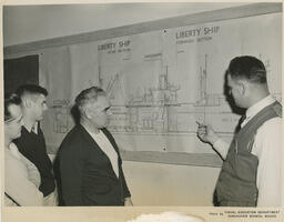 People looking at plan of a ship, ca. 1954