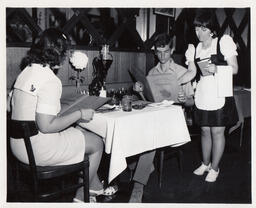 Server points to menu, ca. 1972