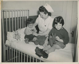 Nurse attending to child and toddler