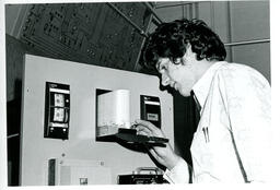Student reads print out on electronic machine