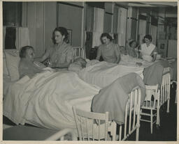 Elderly patients in hospital beds being attended to by VVI Practical Nursing students